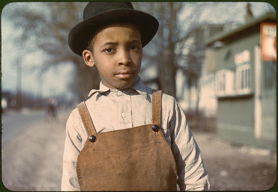 Young boy in overalls and hat