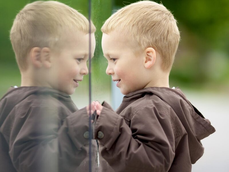 Young Boy Looking in Mirror