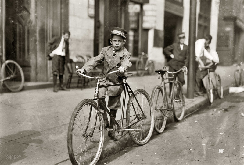 Young boy on bicycle in city