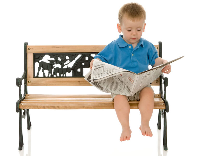 Young Boy Reading Newspaper