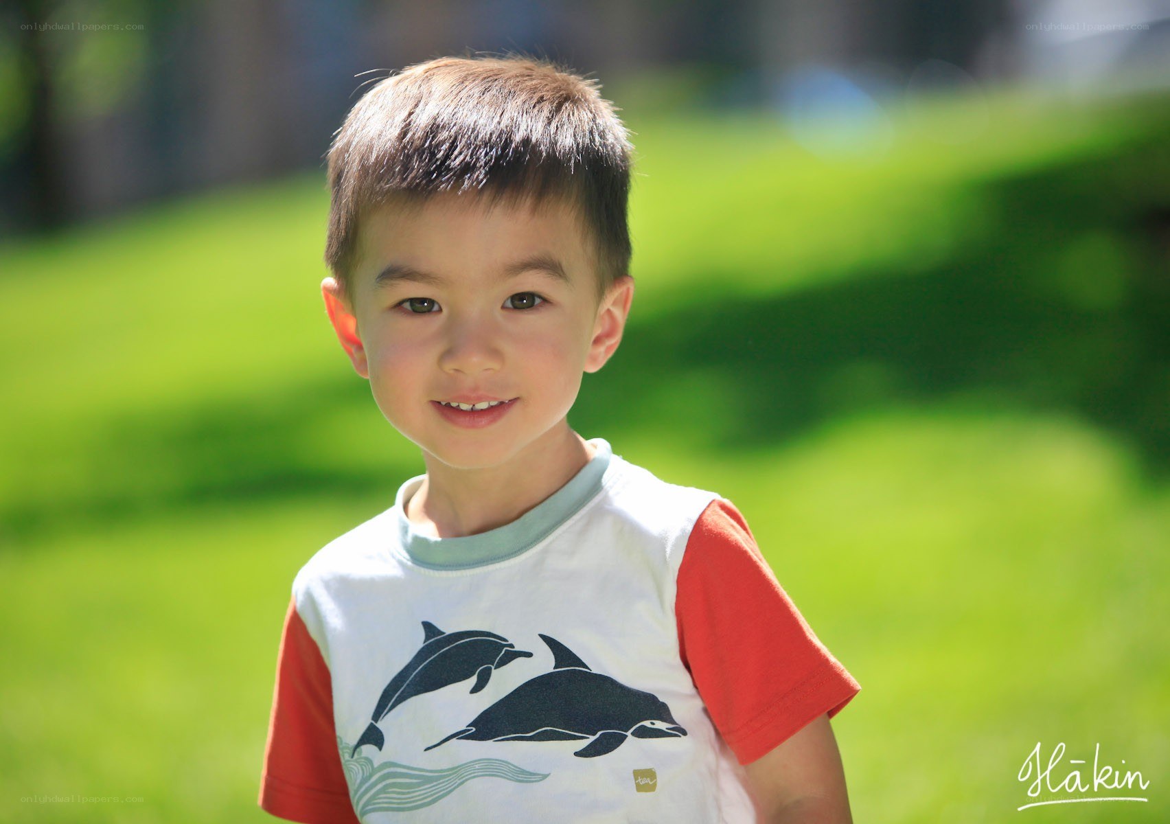 Young boy smiling outdoors