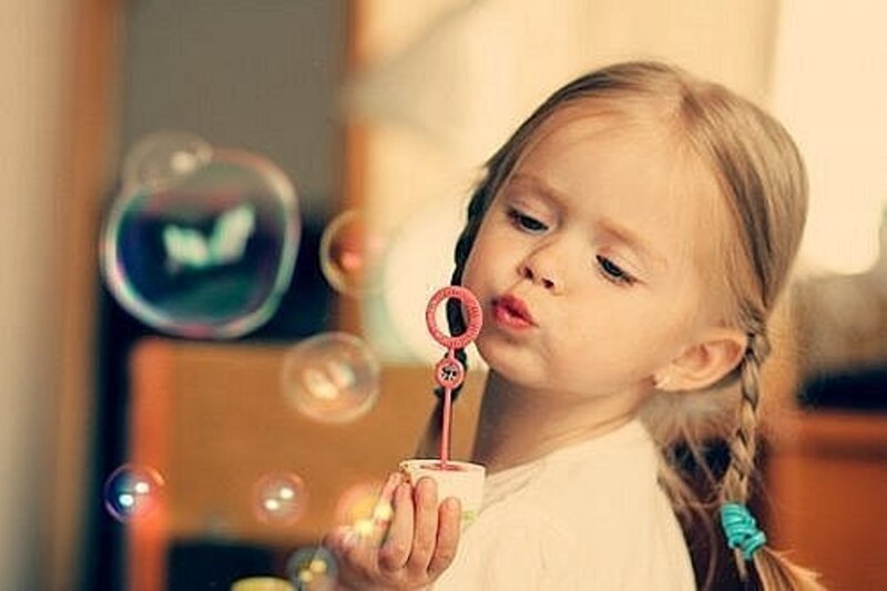 Young Girl Blowing Bubbles