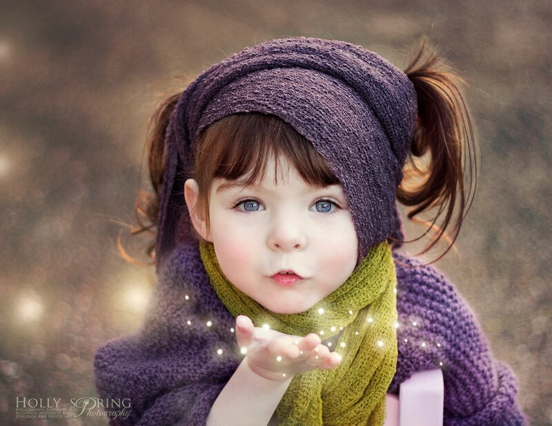 Young Girl Blowing Sparkles