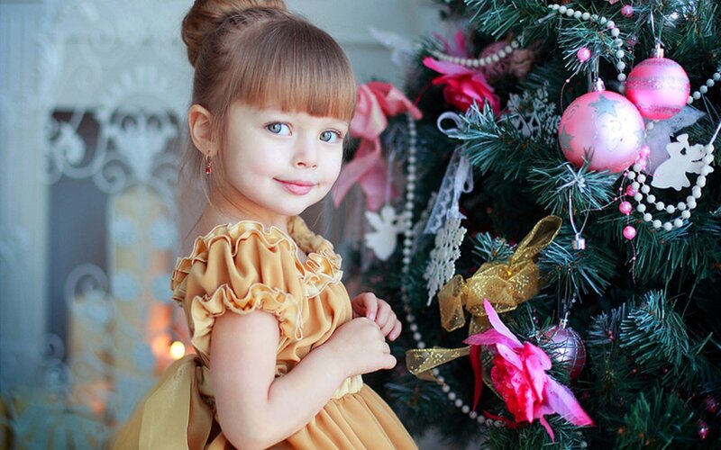 Young Girl by Christmas Tree
