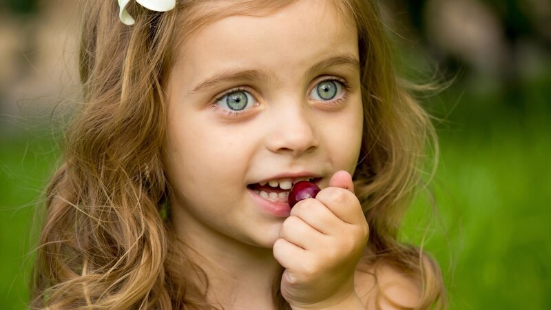 Young Girl Eating Grape