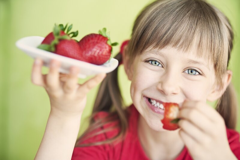 Young Girl Eating Strawberries