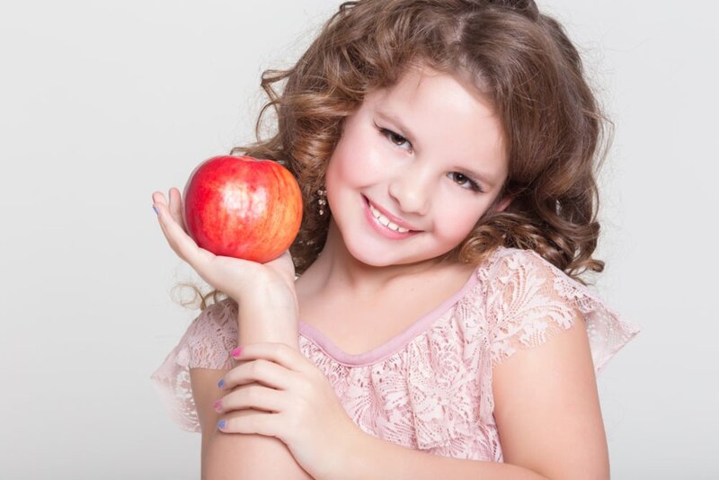 Young Girl Holding Apple