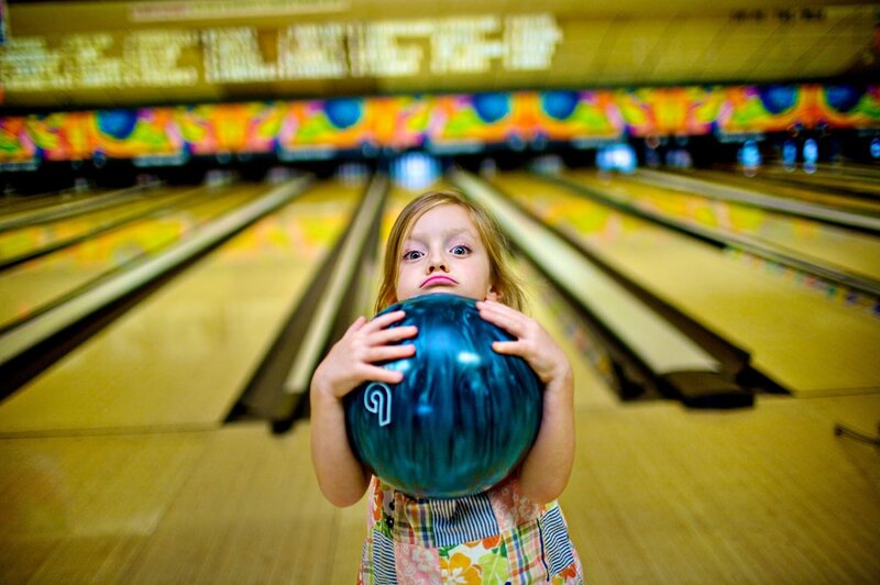 Young Girl Holding Bowling Ball