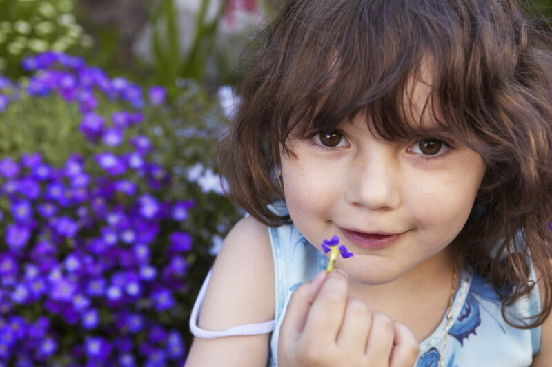 Young Girl Holding Flower — Purple