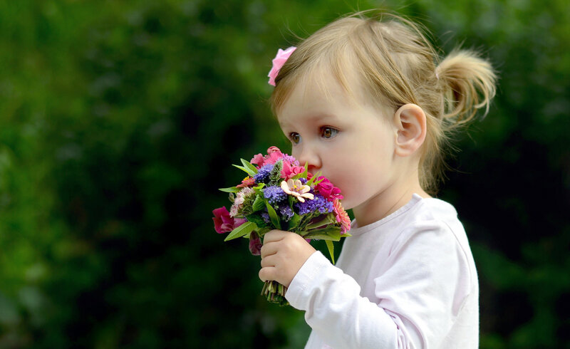Young Girl Holding Flowers — Green