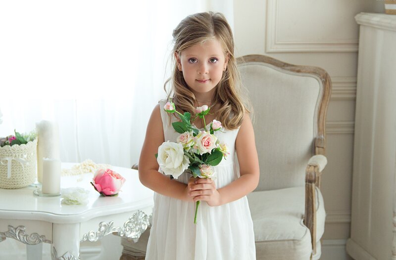Young Girl Holding Flowers — White, Serene