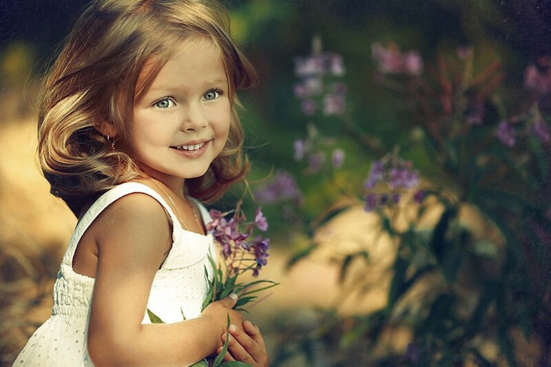 Young Girl Holding Flowers — White
