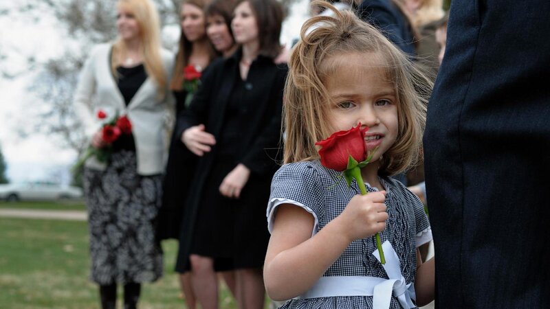 Young girl holding red rose