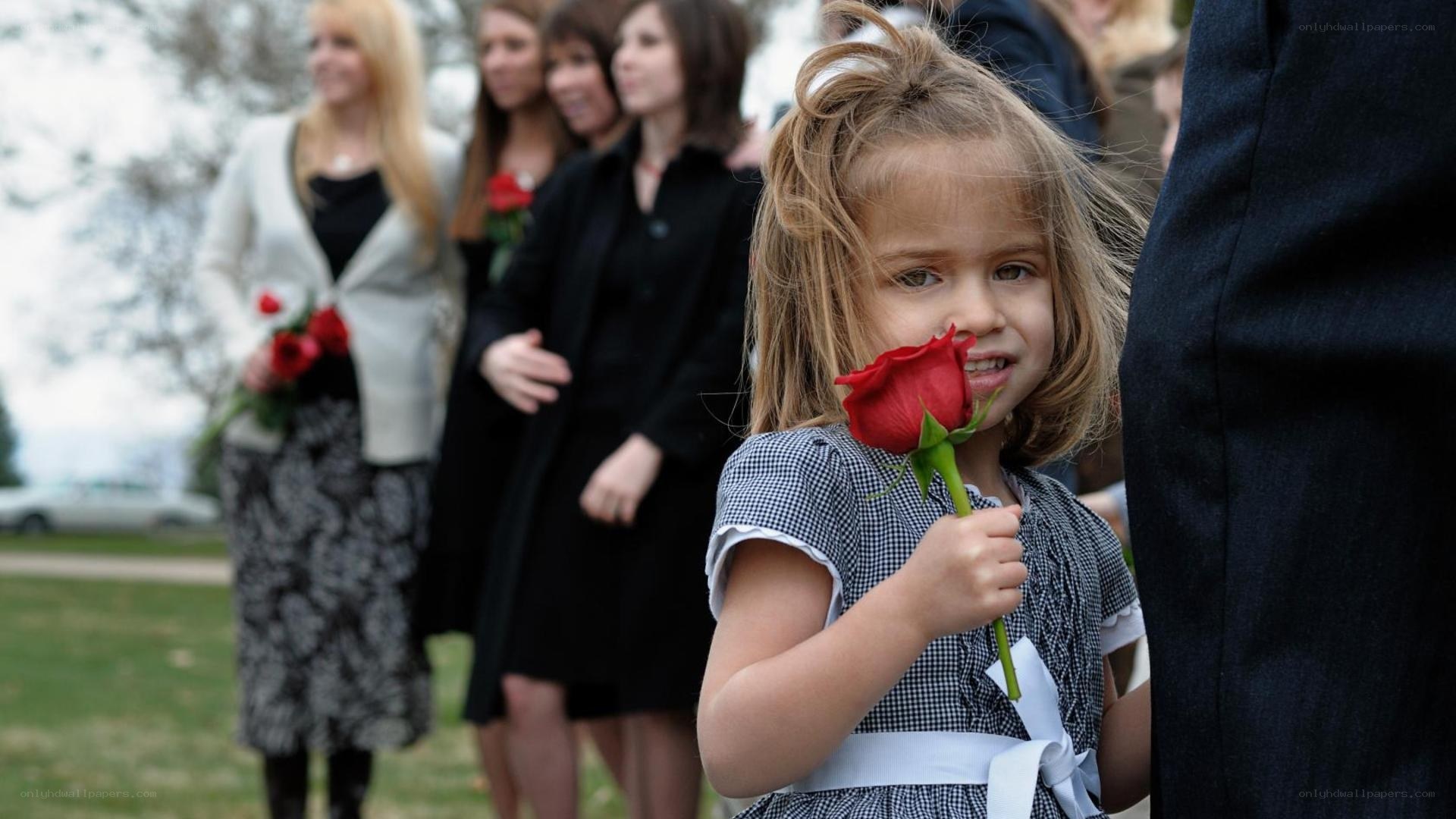 Young girl holding red rose