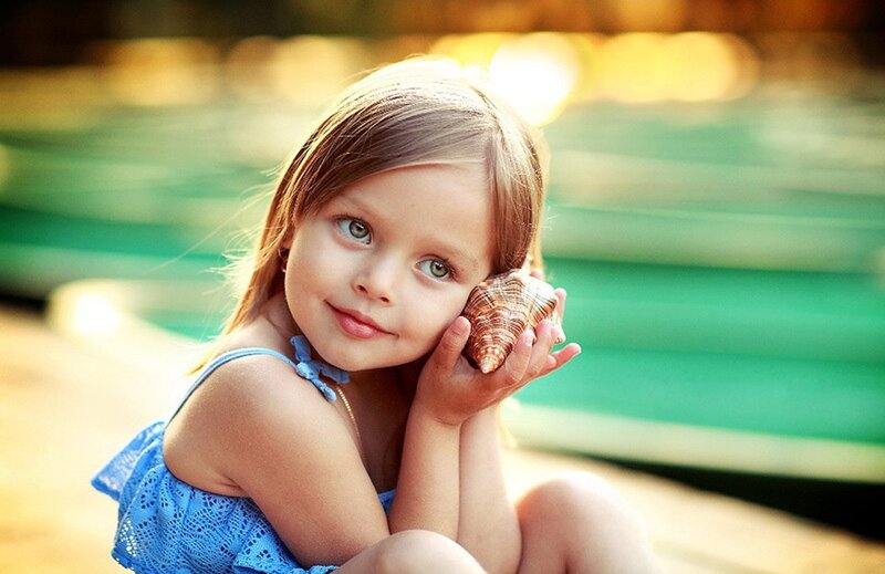 Young Girl Holding Shell