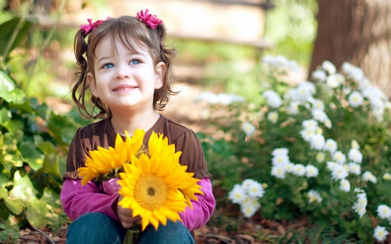 Young Girl Holding Sunflowers