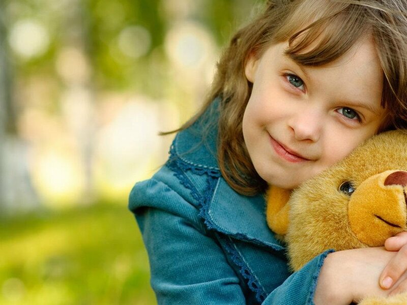 Young Girl Hugging Teddy Bear