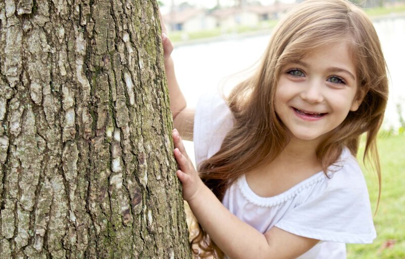 Young Girl Hugging Tree