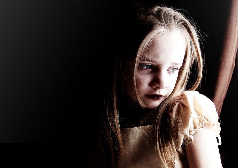 Young Girl in Dark Room