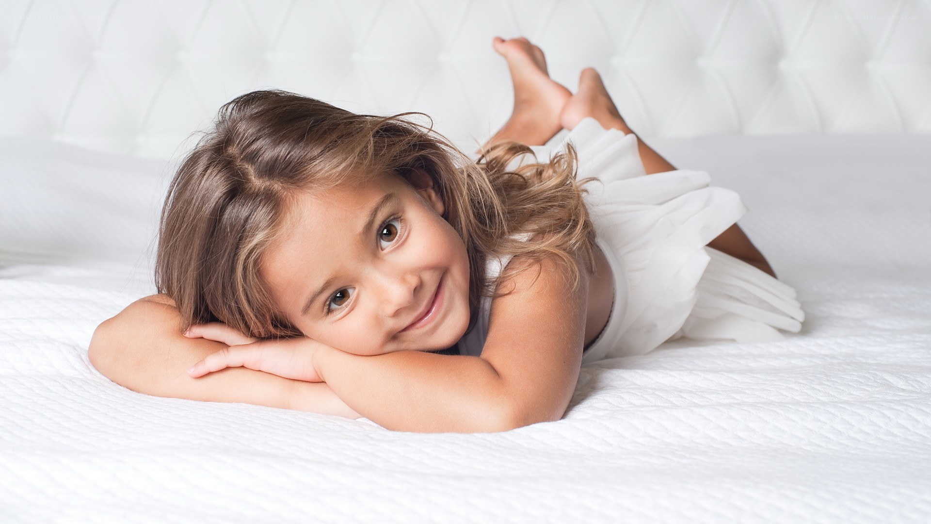young girl lying on bed