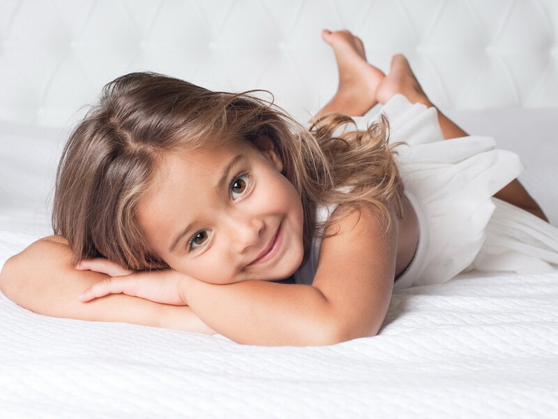 Young Girl Lying on Bed — White, Calm