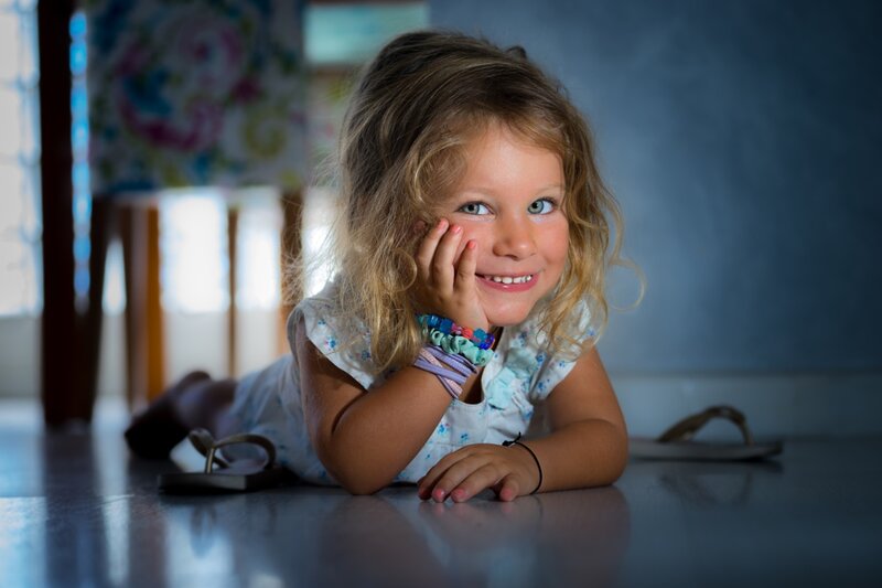 Young Girl Lying on Floor — Blue