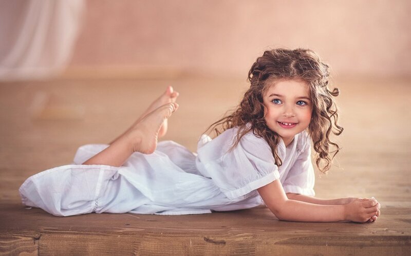 Young Girl Lying on Floor — White
