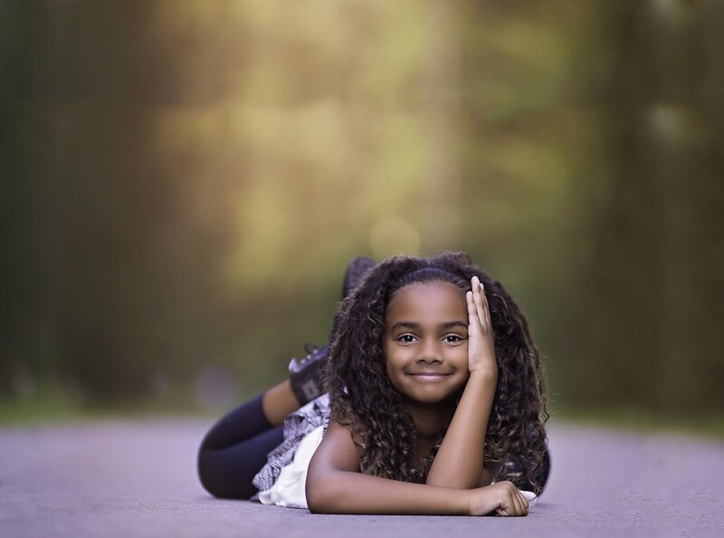Young Girl Lying on Ground — Brown
