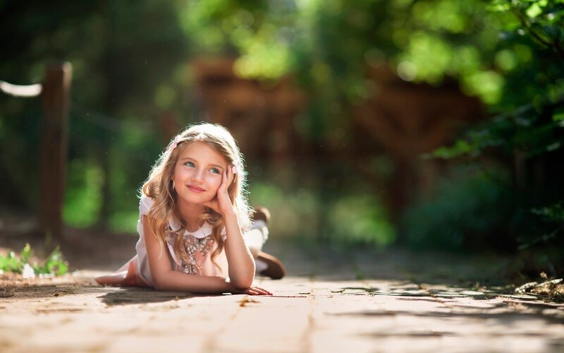Young Girl Lying on Ground — Green