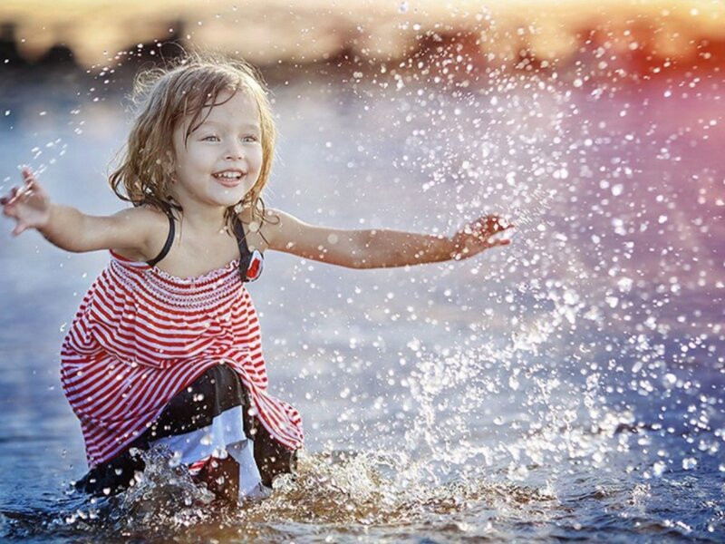 Young Girl Playing in Water