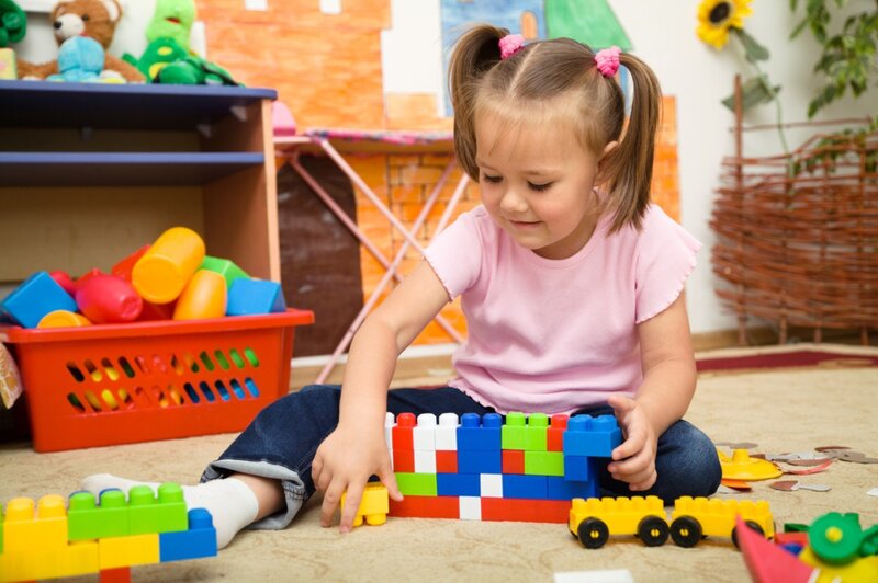 Young Girl Playing with Blocks