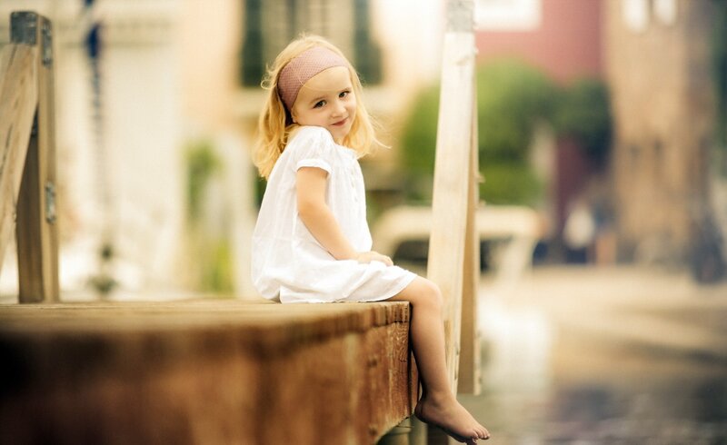 Young Girl Sitting on Dock — White