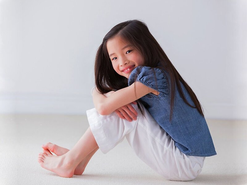 Young Girl Sitting on Floor — White
