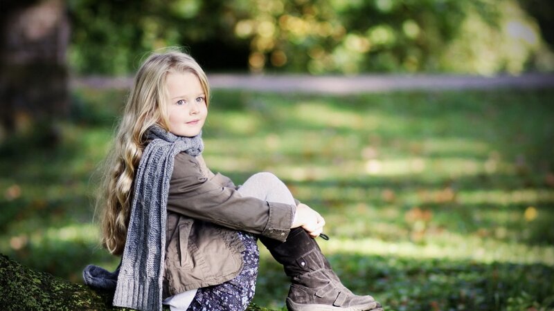 Young Girl Sitting on Log