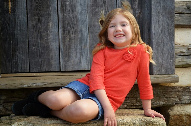Young Girl Sitting on Stone