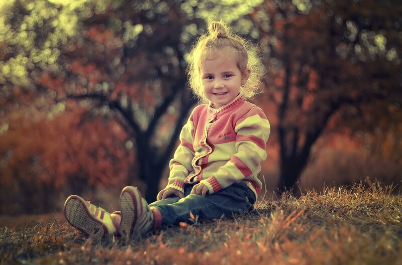 Young Girl Sitting Outdoors — Orange