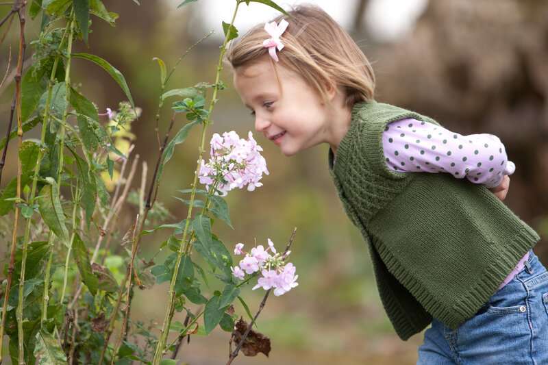 Young Girl Smelling Flowers — Green