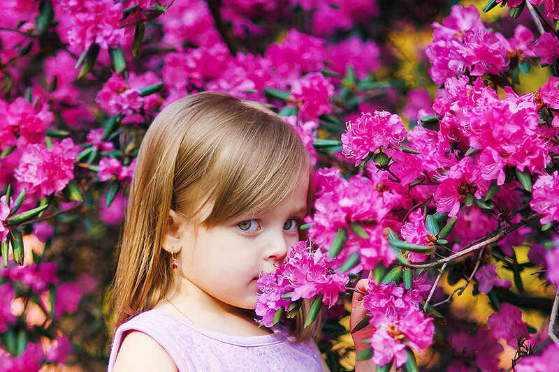 Young Girl Smelling Flowers