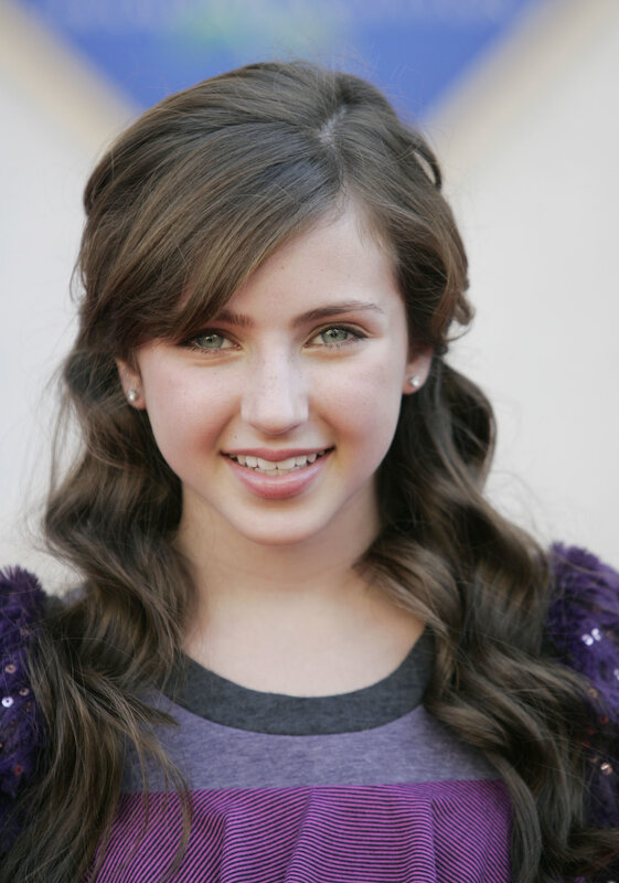 young girl with brown hair smiling