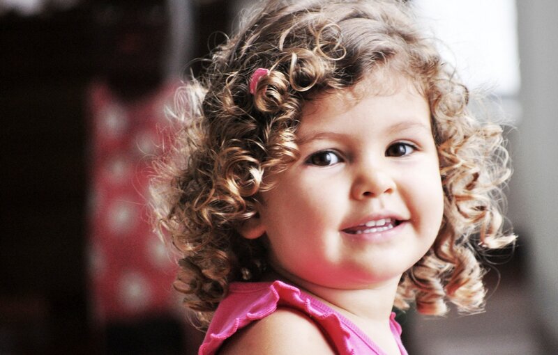 Young Girl with Curly Hair — Brown, Happy