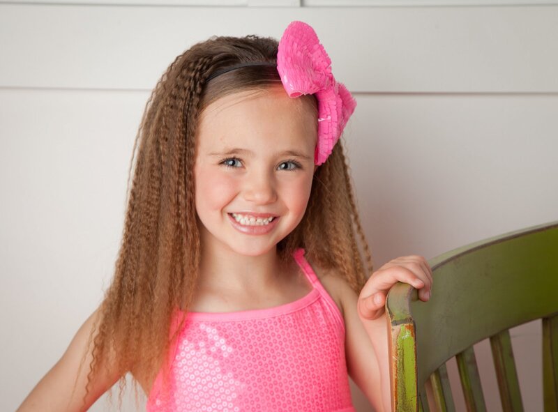 Young Girl with Pink Bow — Happy