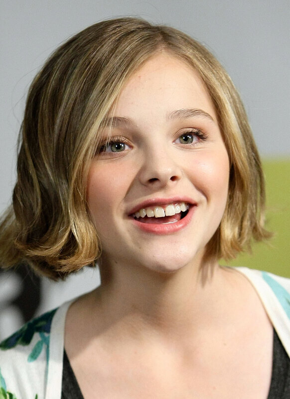 young girl with short hair smiling