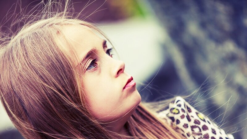 young girl with thoughtful expression