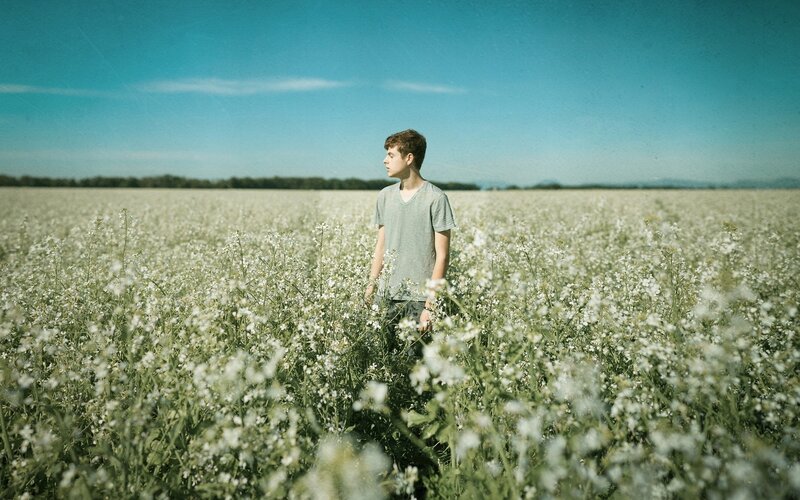 Young man in a flower field