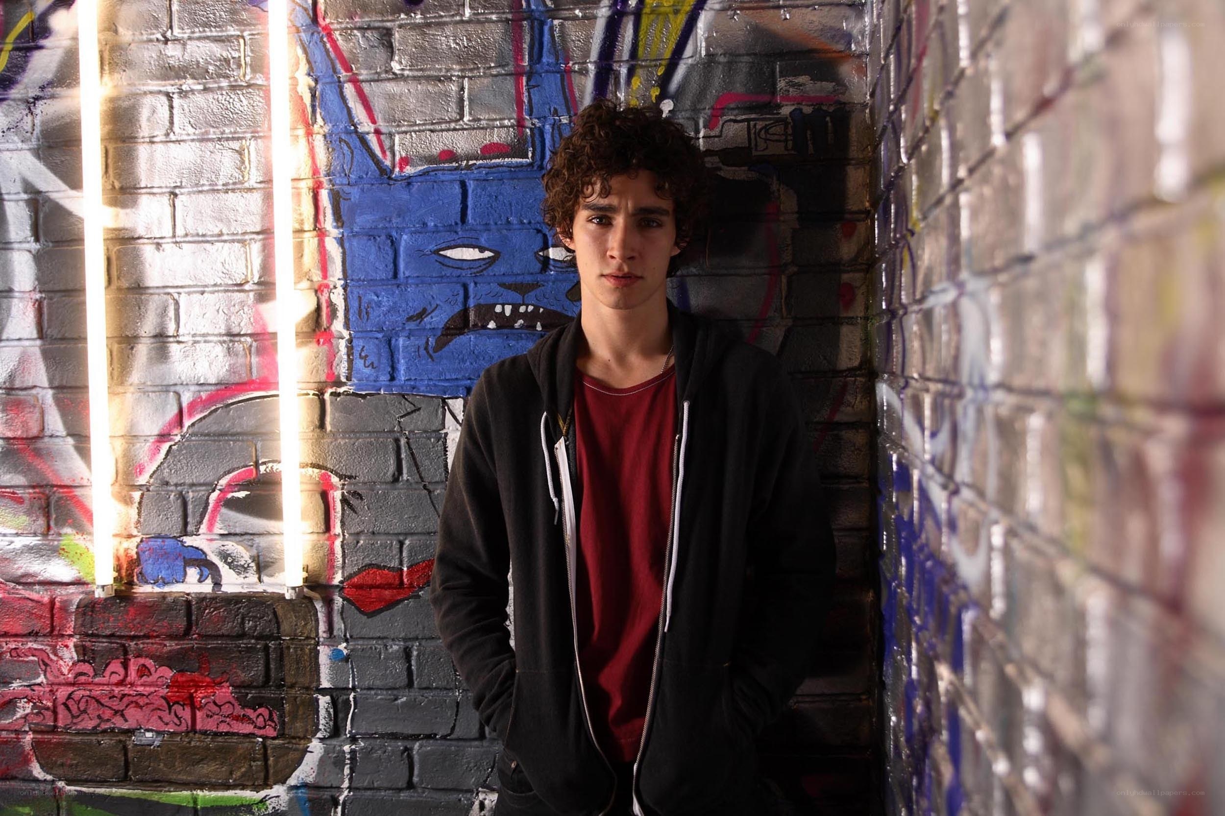 Young man in graffiti alley