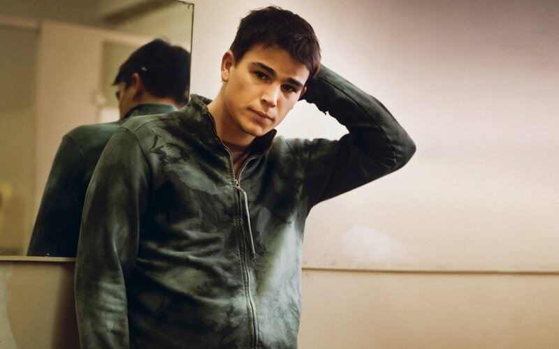 Young Man in Green Jacket — Serious