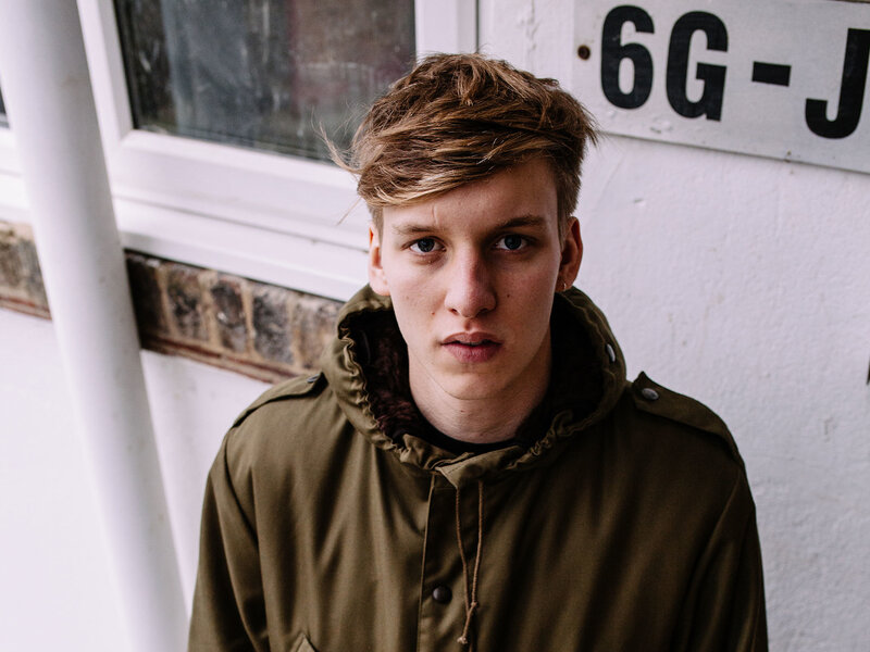 young man in green jacket