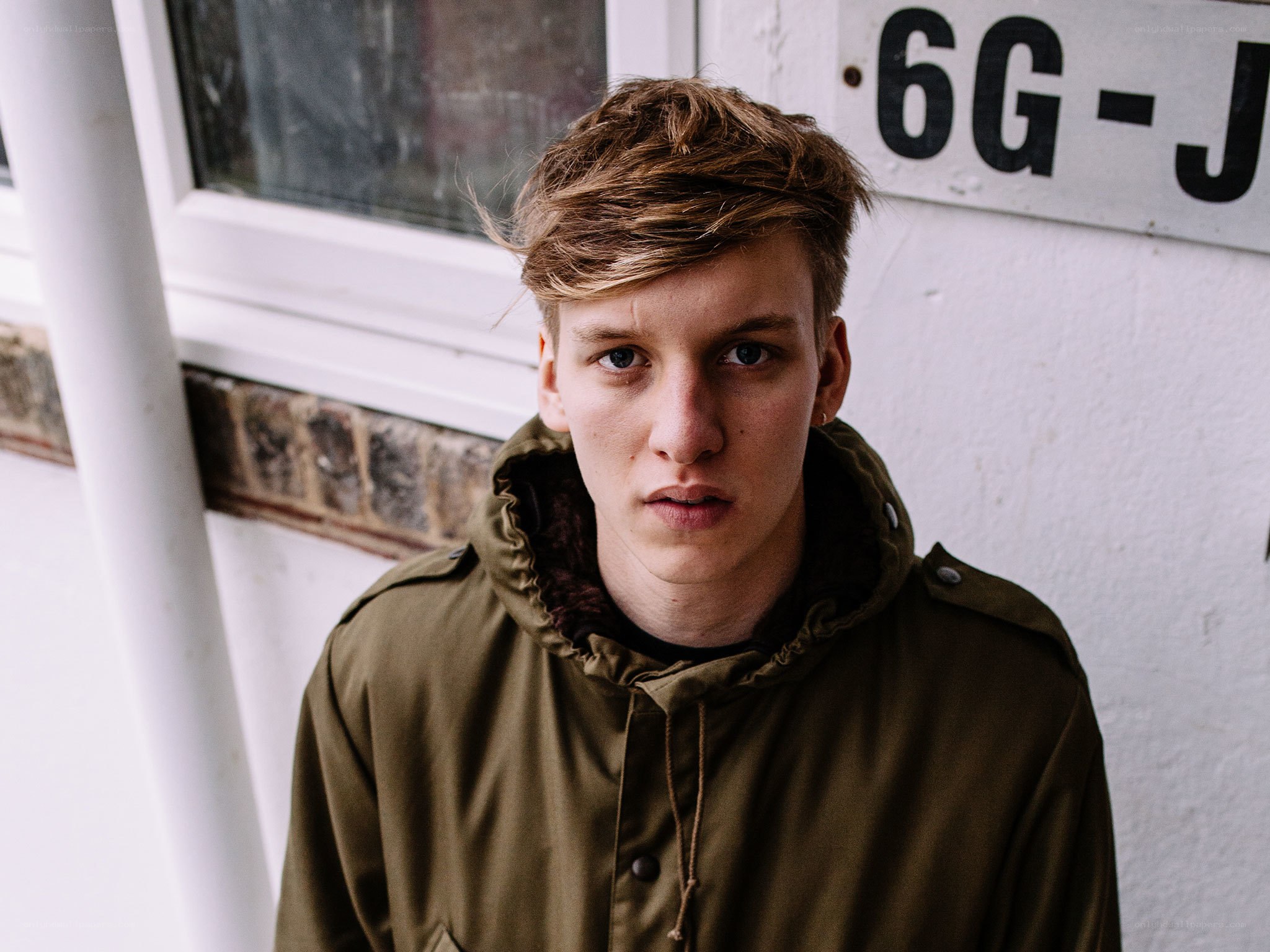young man in green jacket