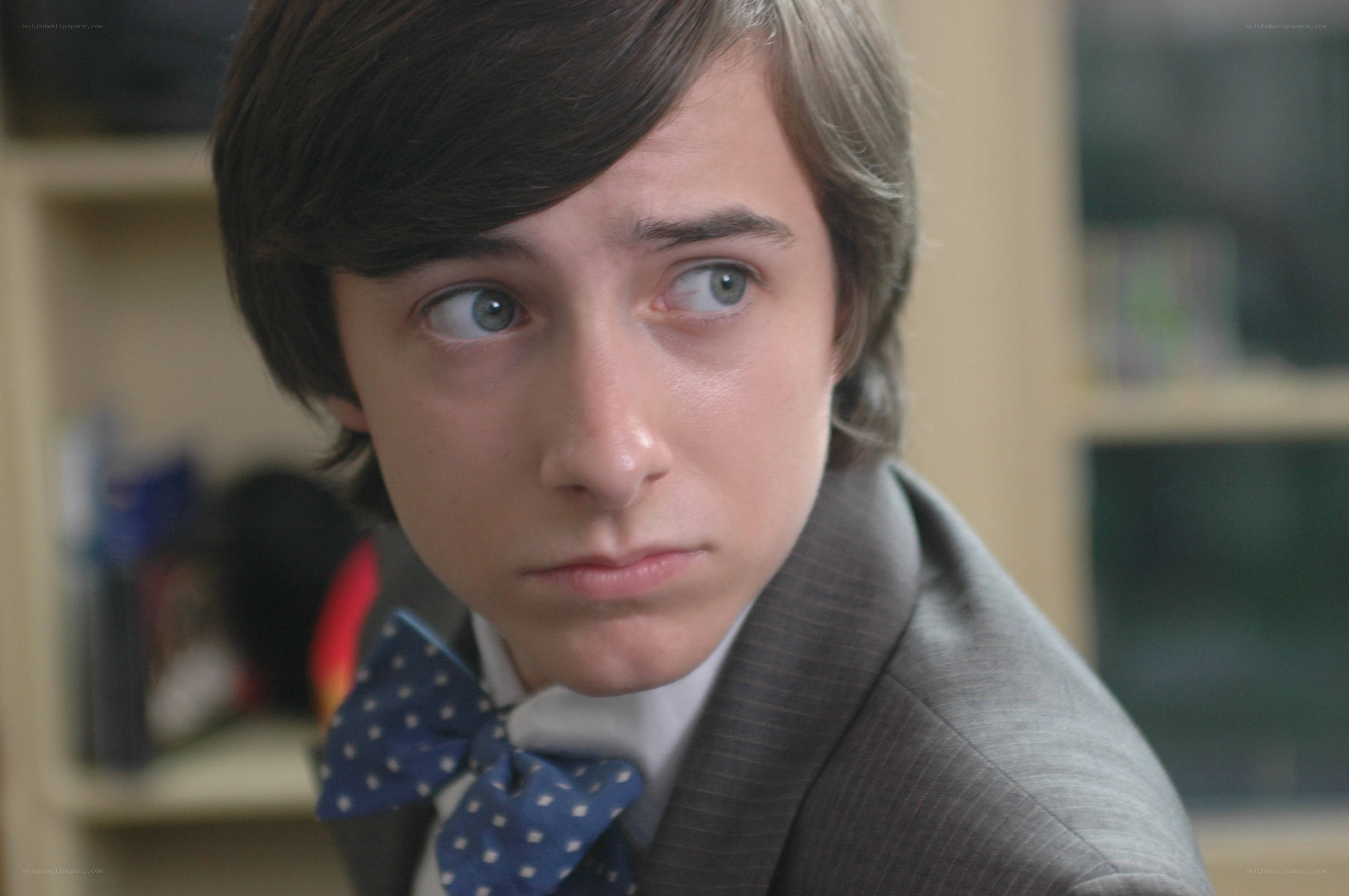 young man in suit looking surprised