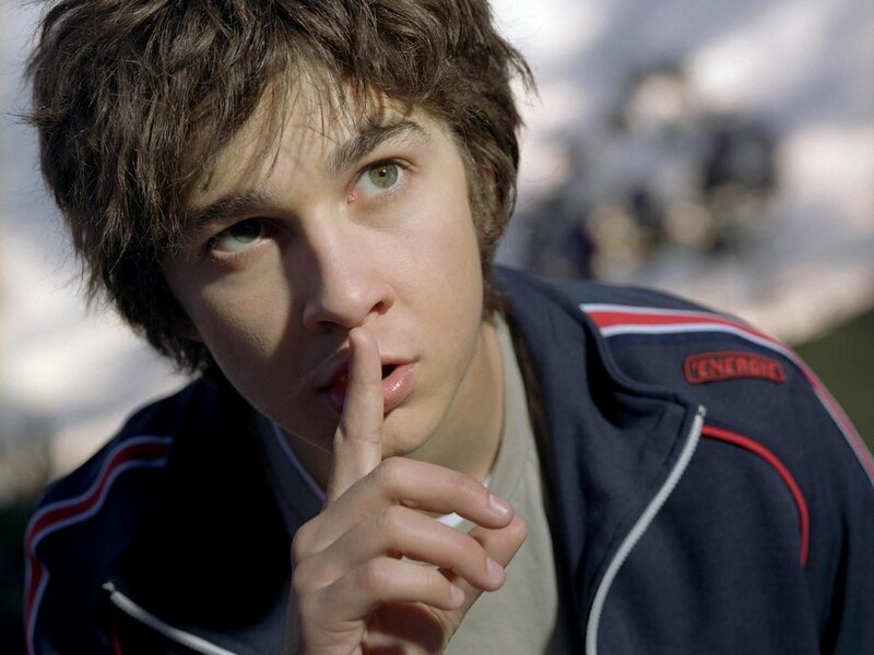 Young man making shush gesture